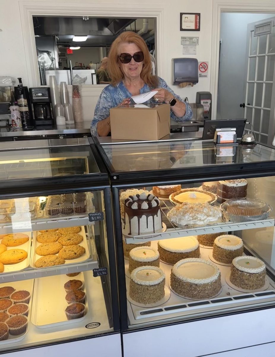 Owner Suzanne Eggli placing a seal on a finished cake. Photo taken by Sasha Funes.